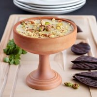 A dish of om ali topped with nuts